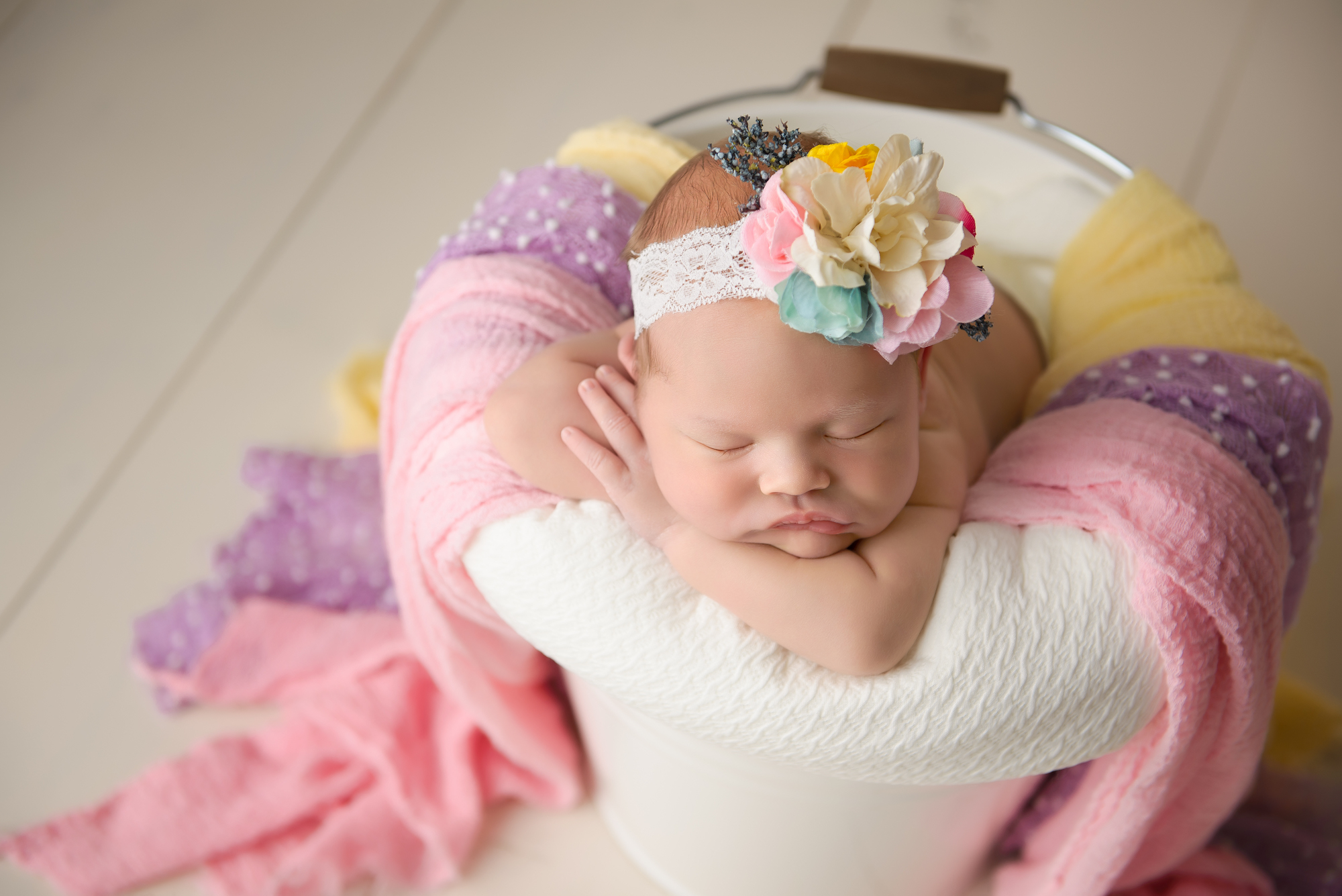Calgary Newborn Photographer Baby On A Colourful Bucket