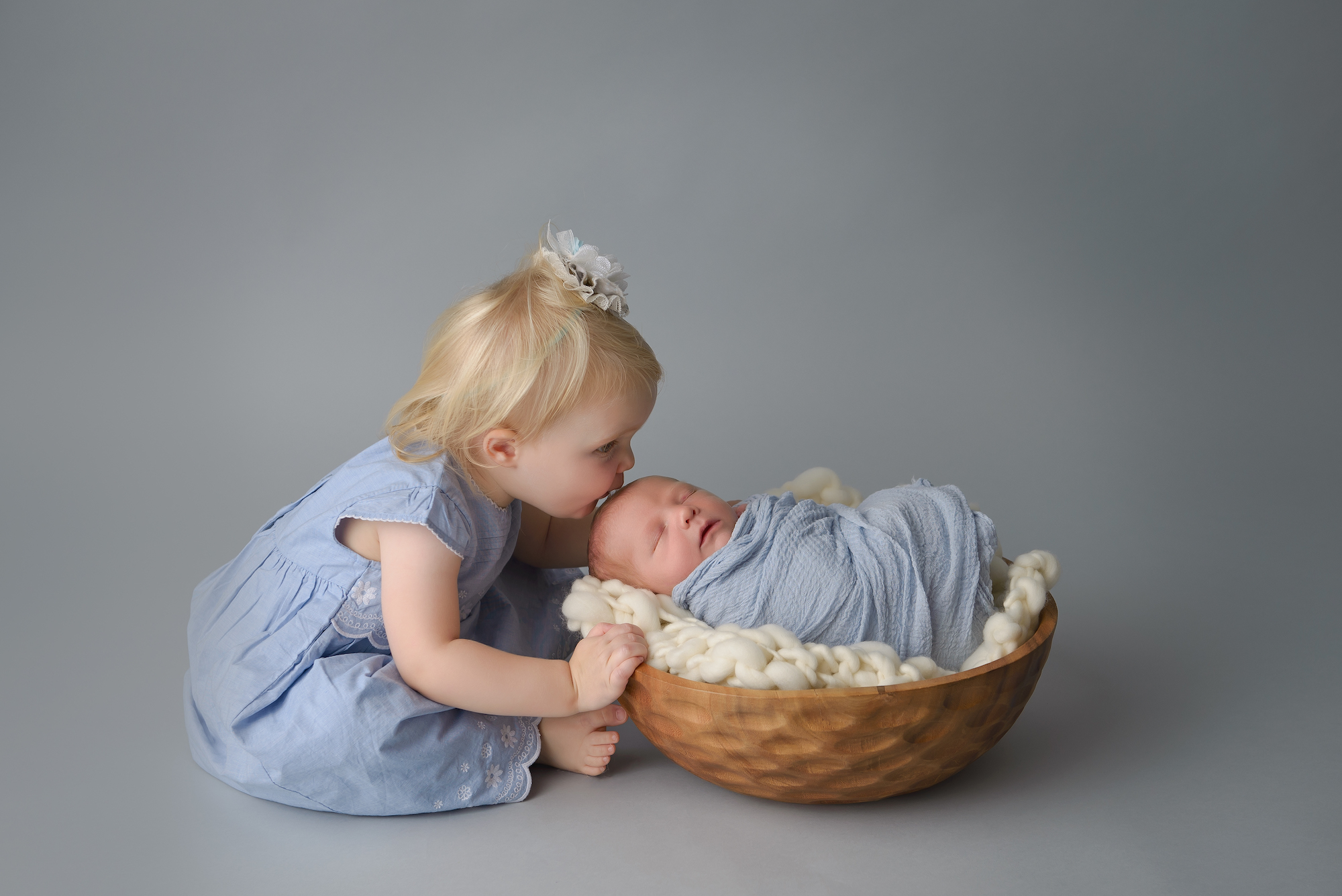 Newborn Photographer Big Sister Kissing Baby Boy