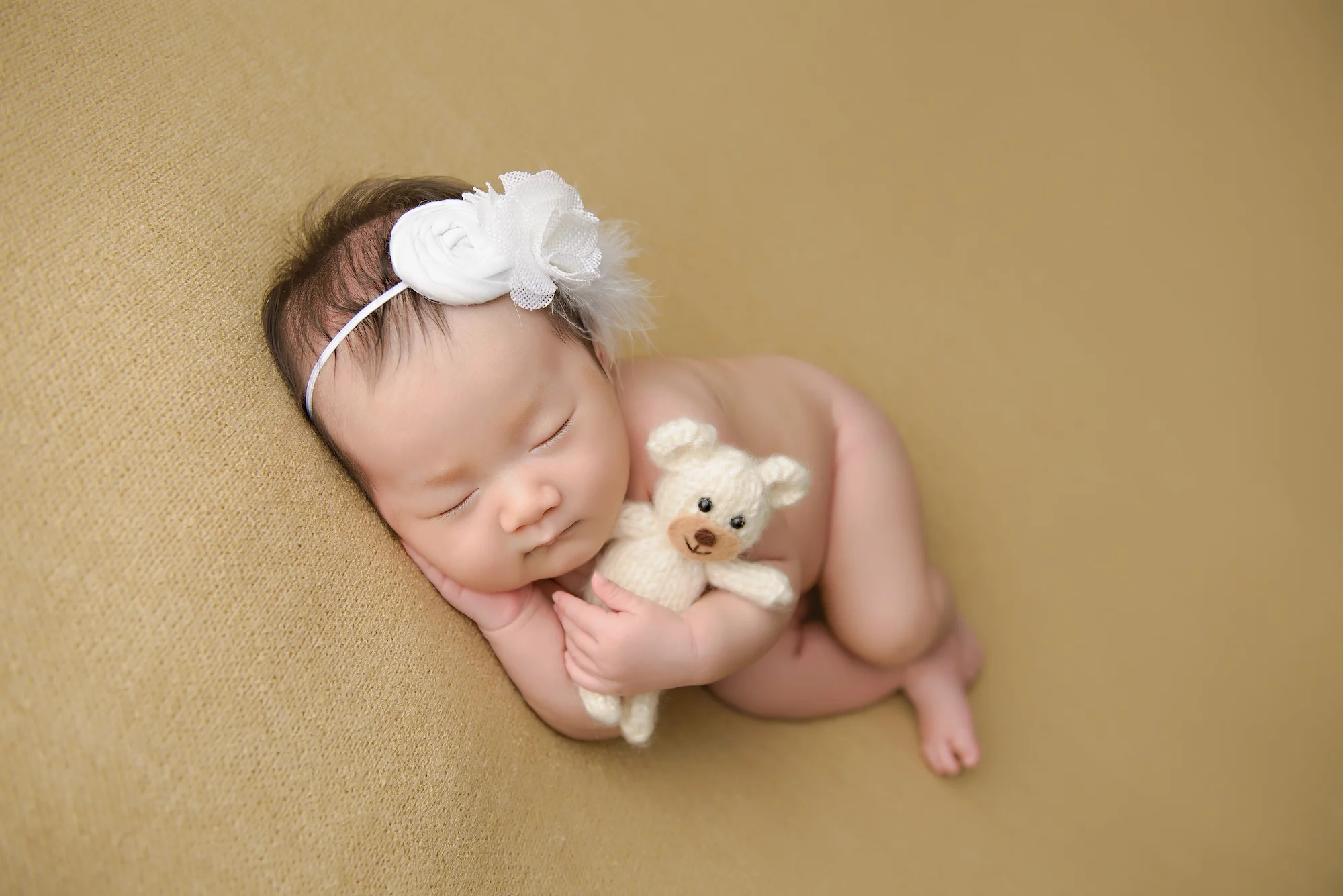 Newborn Photography Calgary Holding Teddy Bear
