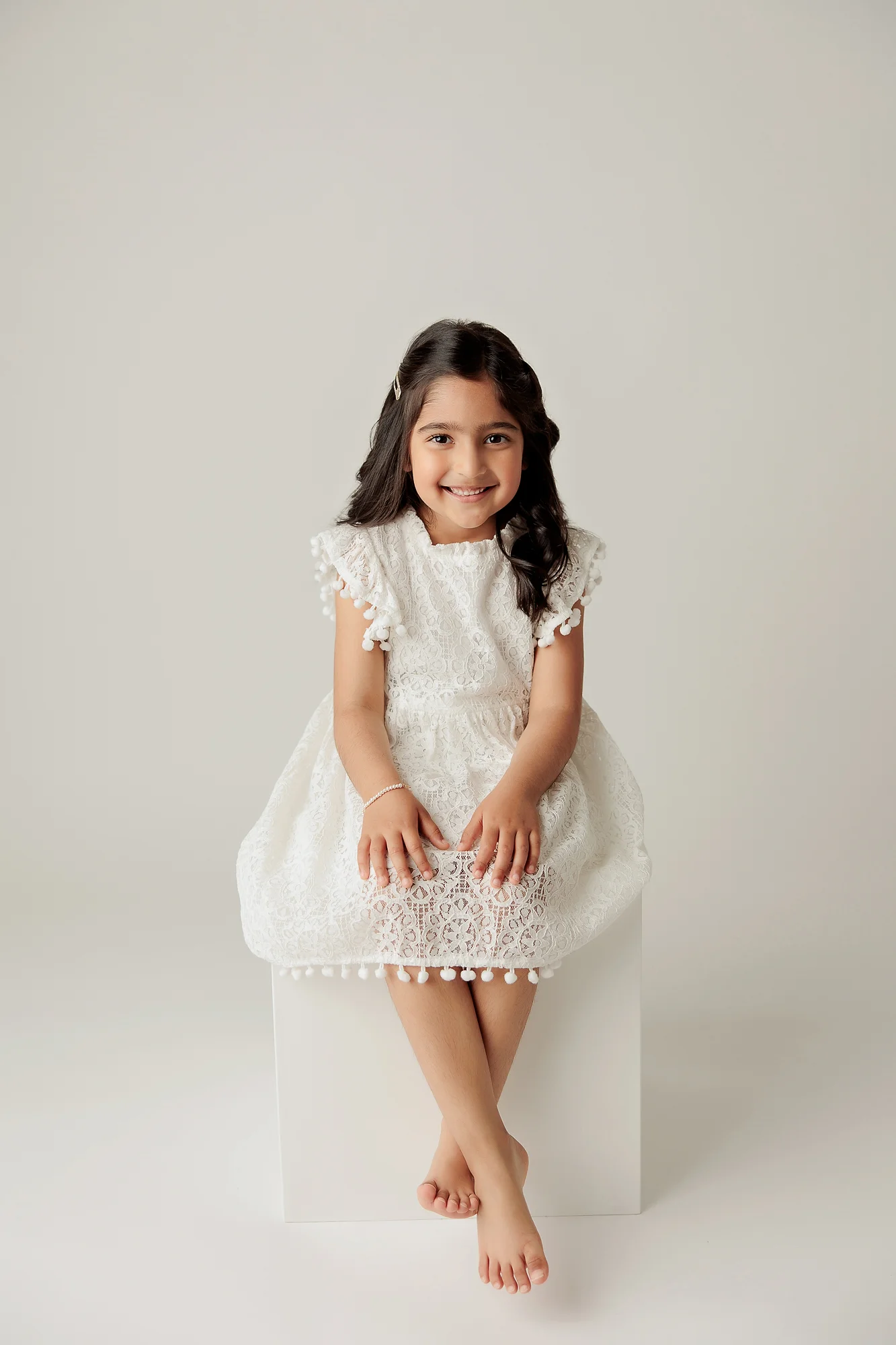 child portrait photography calgary of a girl sitting on a white box