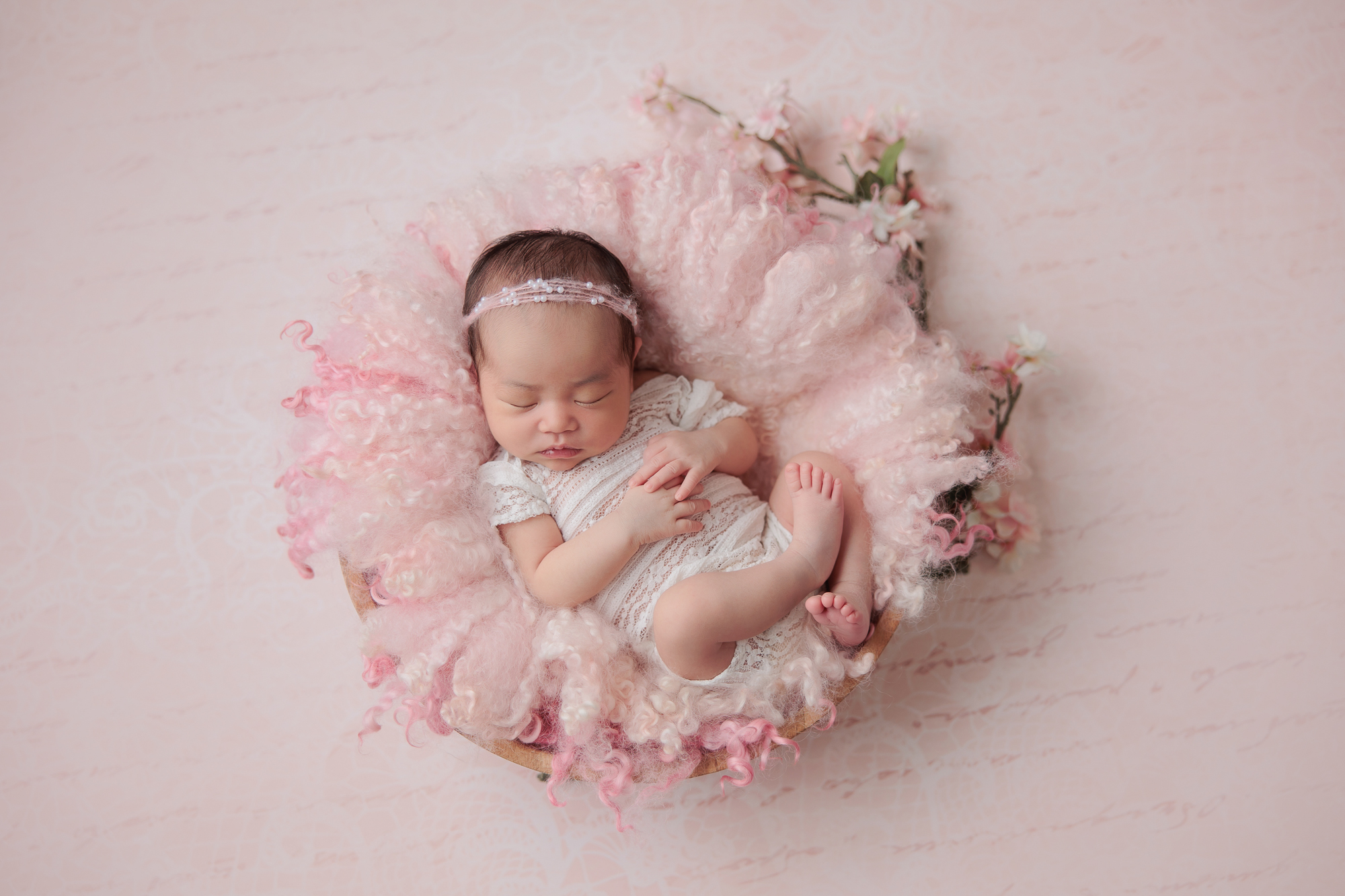 newborn photography calgary baby sleeping on a pink fur