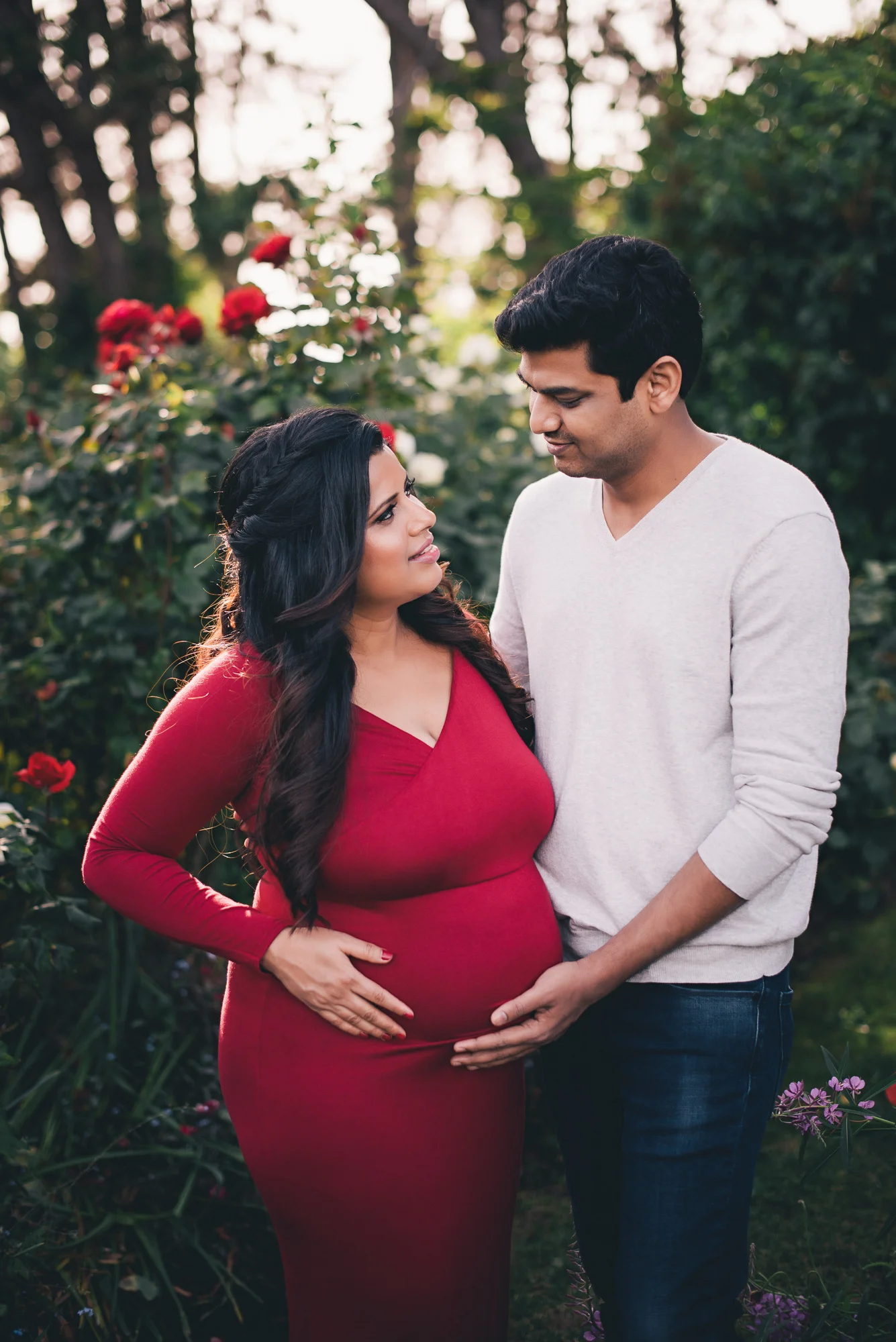 couple holding mom's belly during a maternity photography session