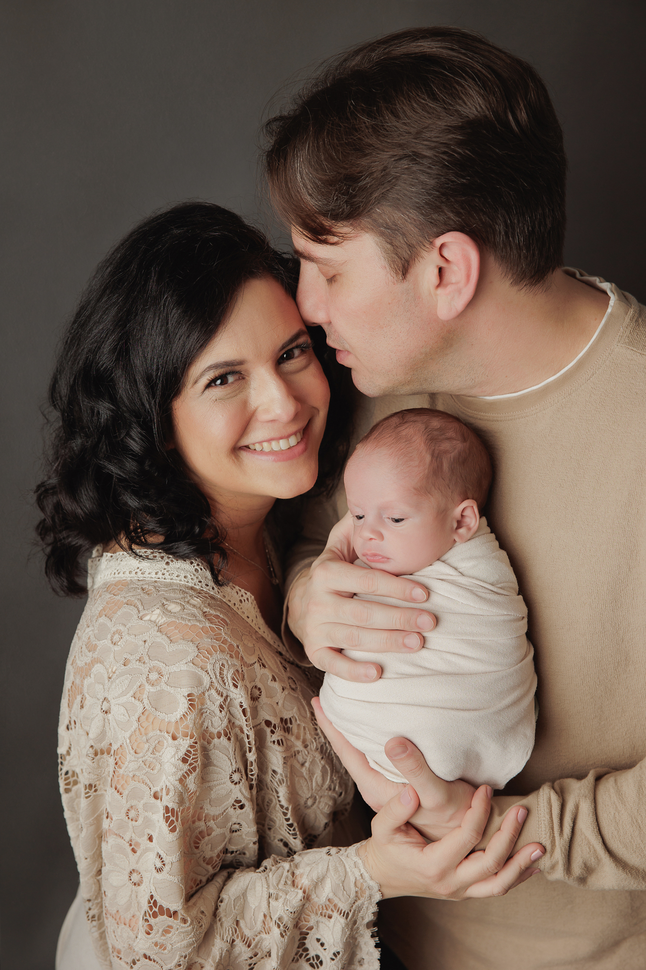 newborn photography new parents holding a newborn baby