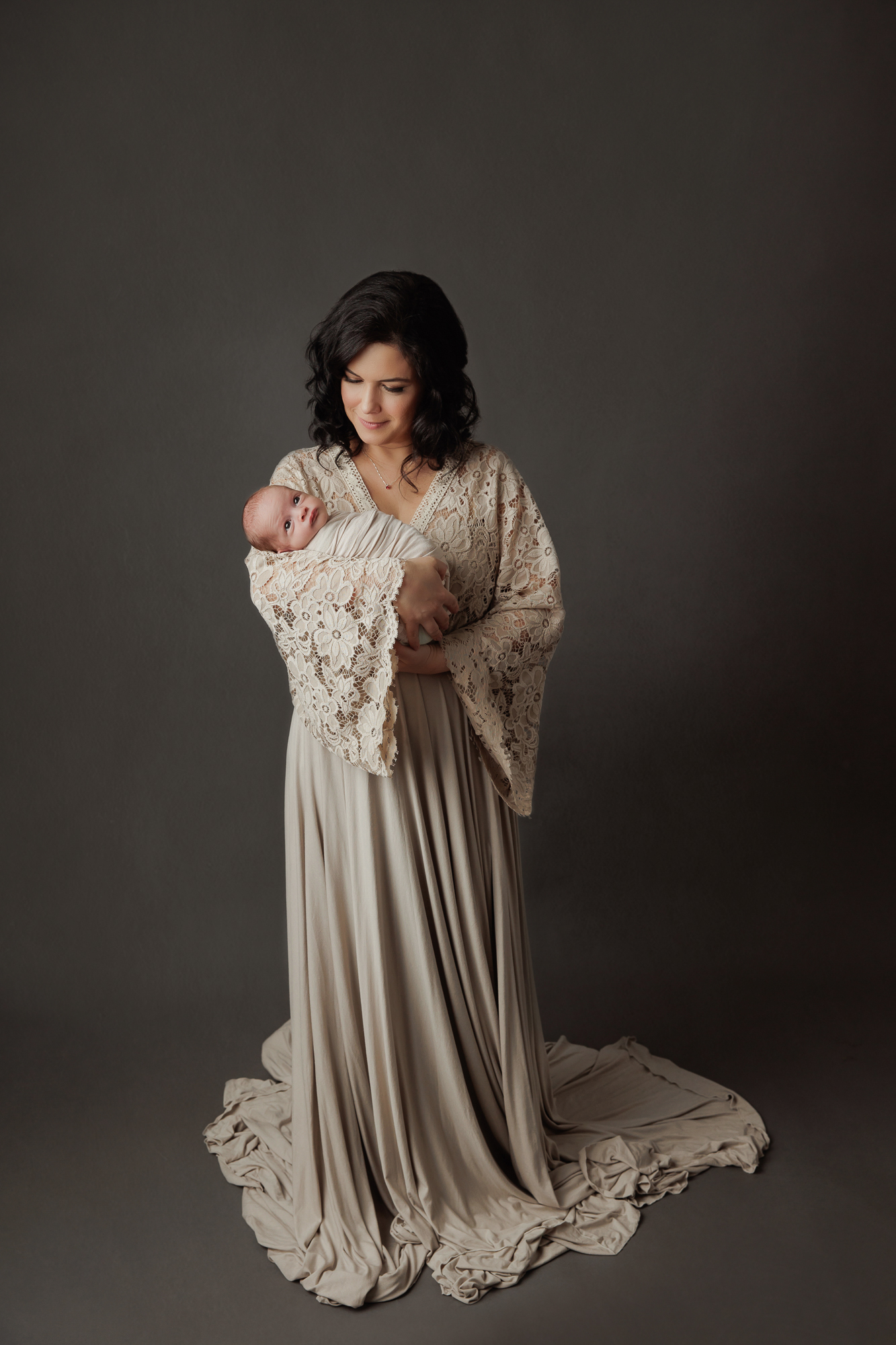 Mom Holding Newborn Baby In Her Arms