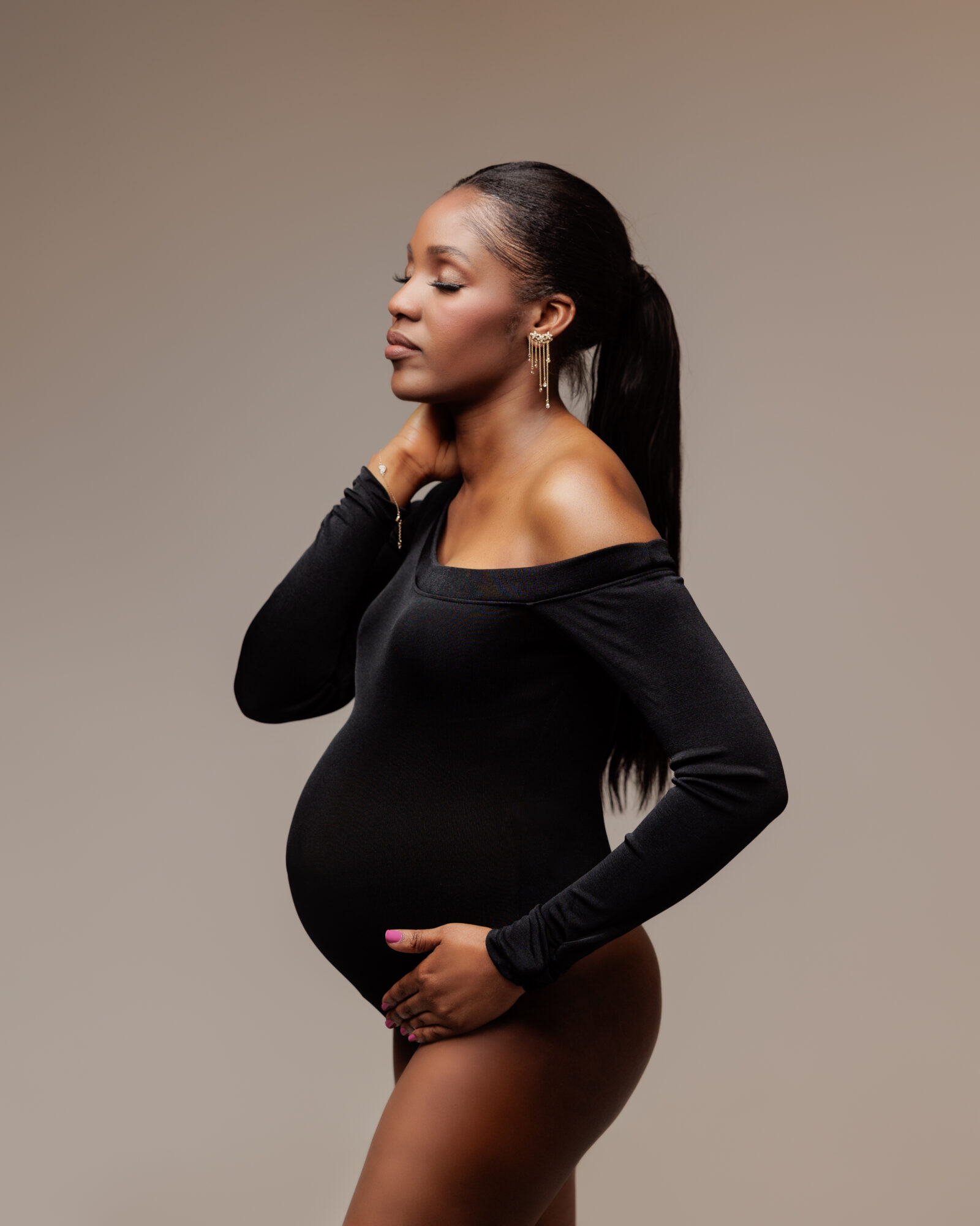 pregnant photoshoot with closed eyes wearing a black dress pregnant photoshoot with closed eyes wearing a black dress