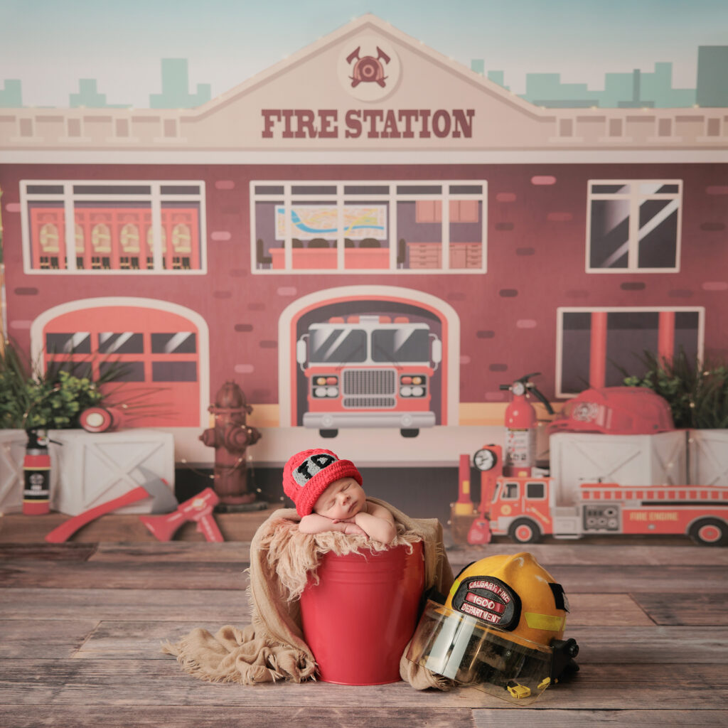 Newborn photography fire department theme baby on a red bucket