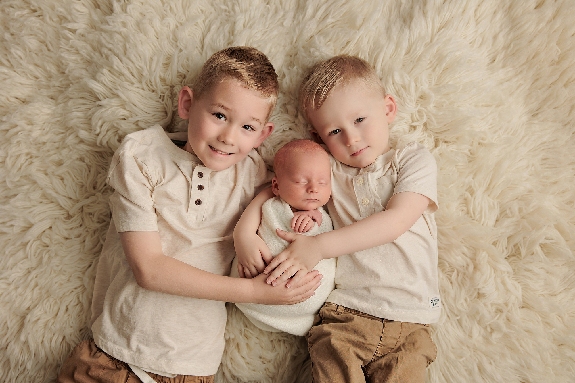 Photographer's booking calendar beside newborn props showing flexible newborn session planning