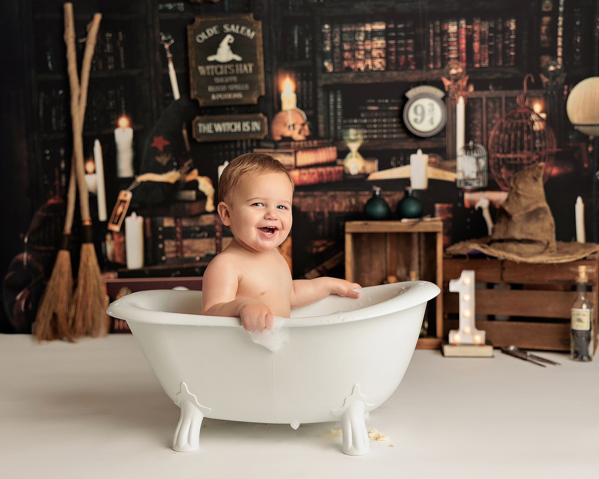 harry potter theme cake smash photoshoot in Calgary on a bathtub harry potter theme cake smash photoshoot in Calgary on a bathtub