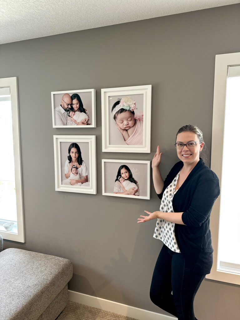 Amanda Dams shows four wall art installed in a Calgary home