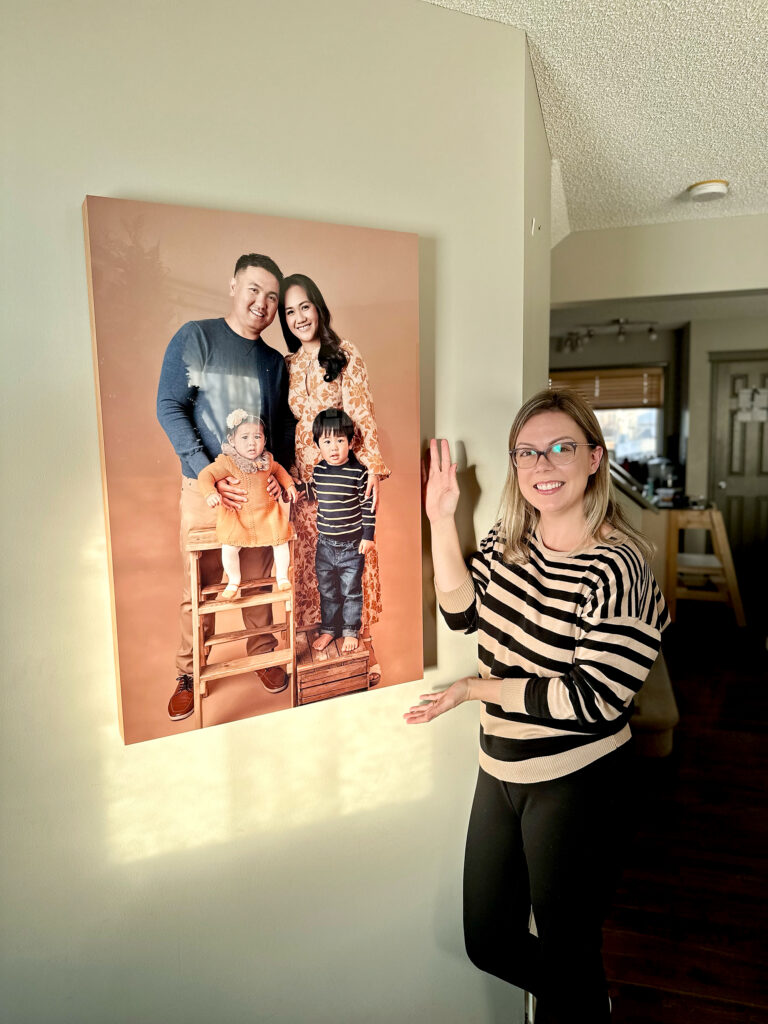 Amanda Dams showing wall art family photo
